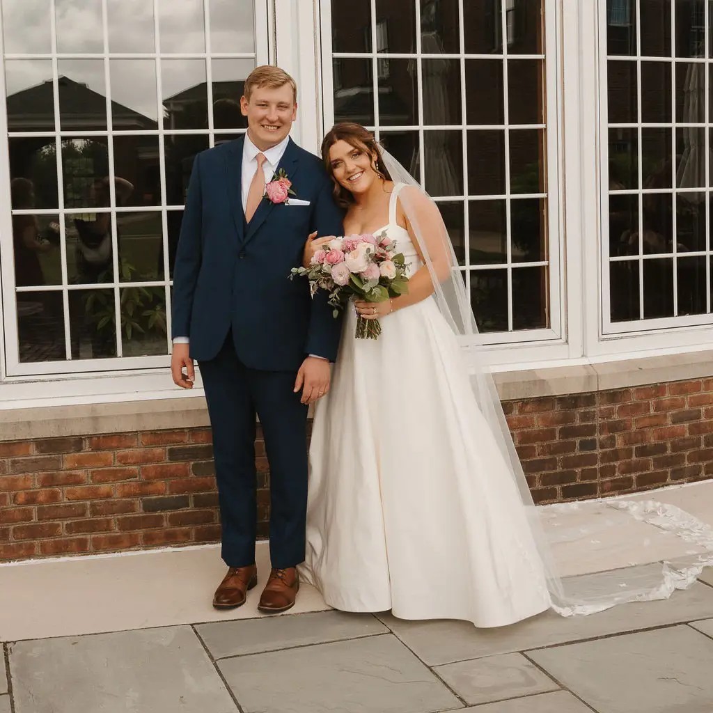 Сouple wearing a white gown and a white suit