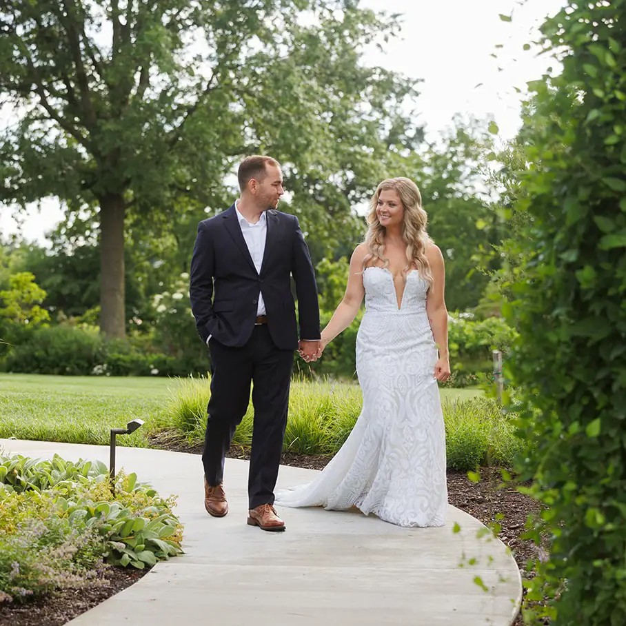 Сouple wearing a white gown and a white suit