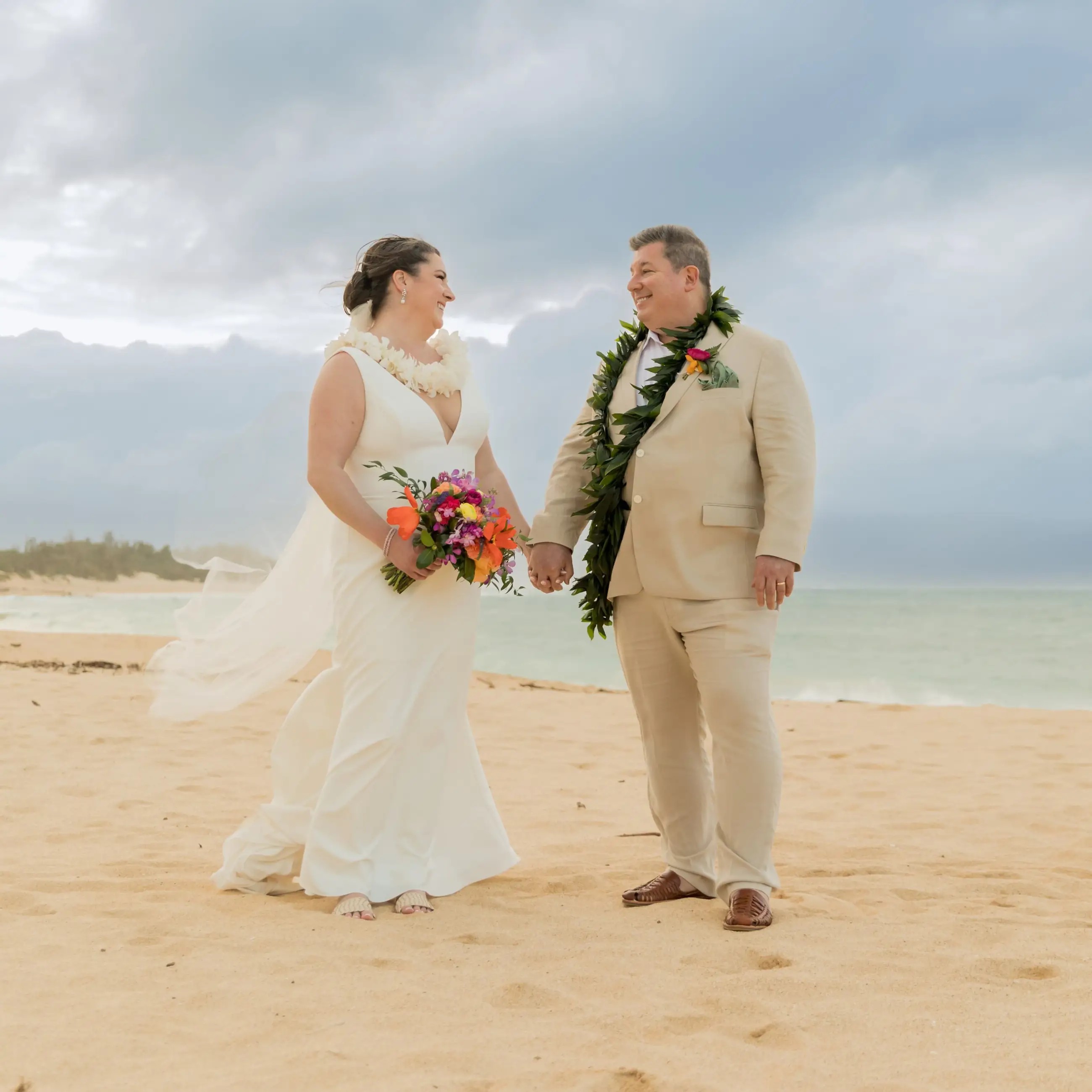 Сouple wearing a white gown and a white suit