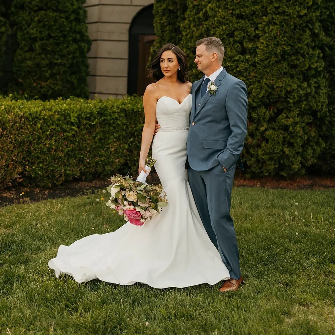 Сouple wearing a white gown and a white suit